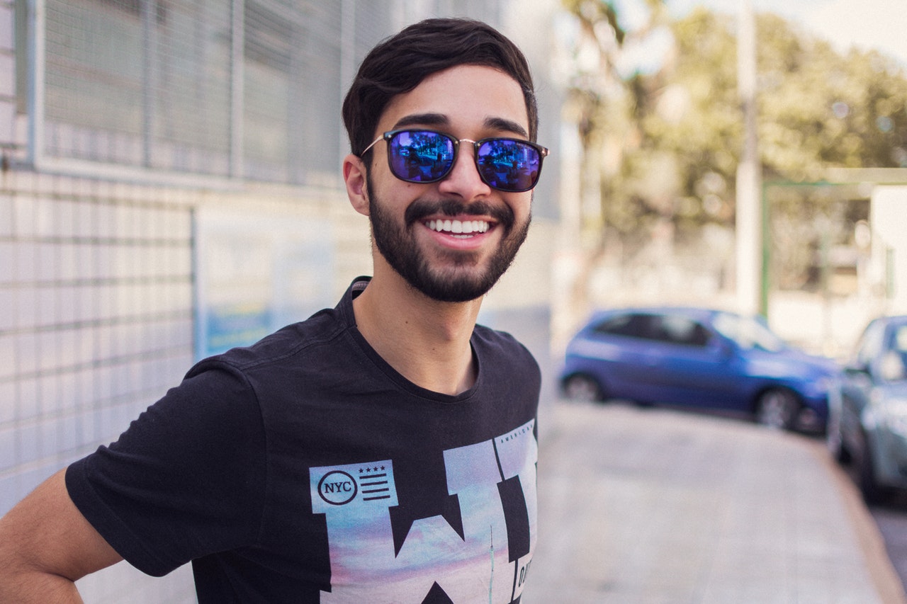 man with sunglasses and white teeth