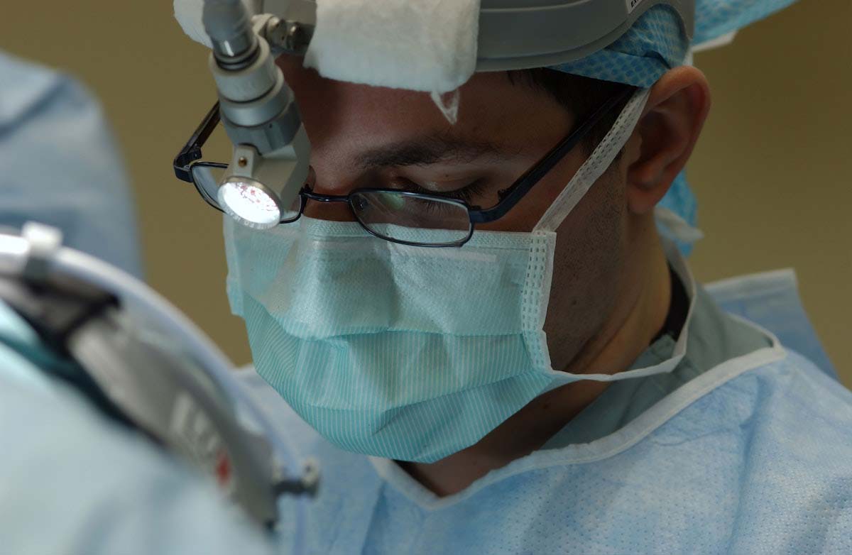 Oral surgeon treating oral cancer