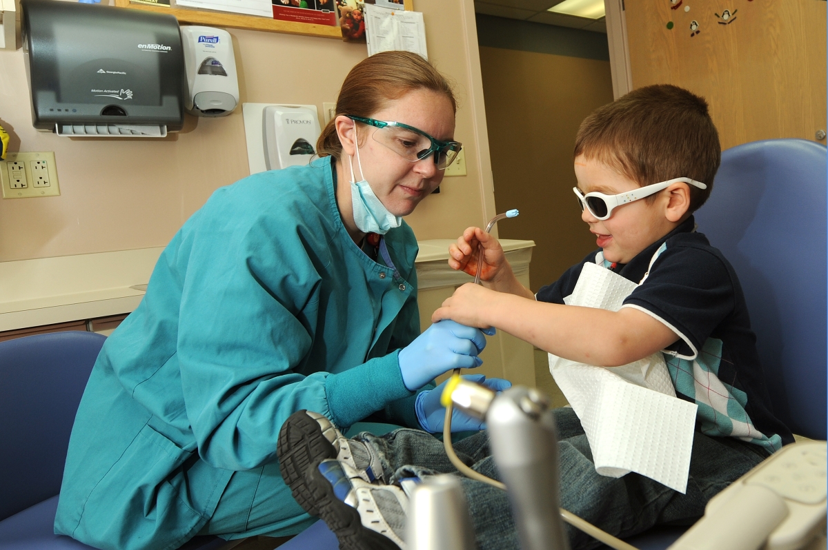 pediatric dentist helping child