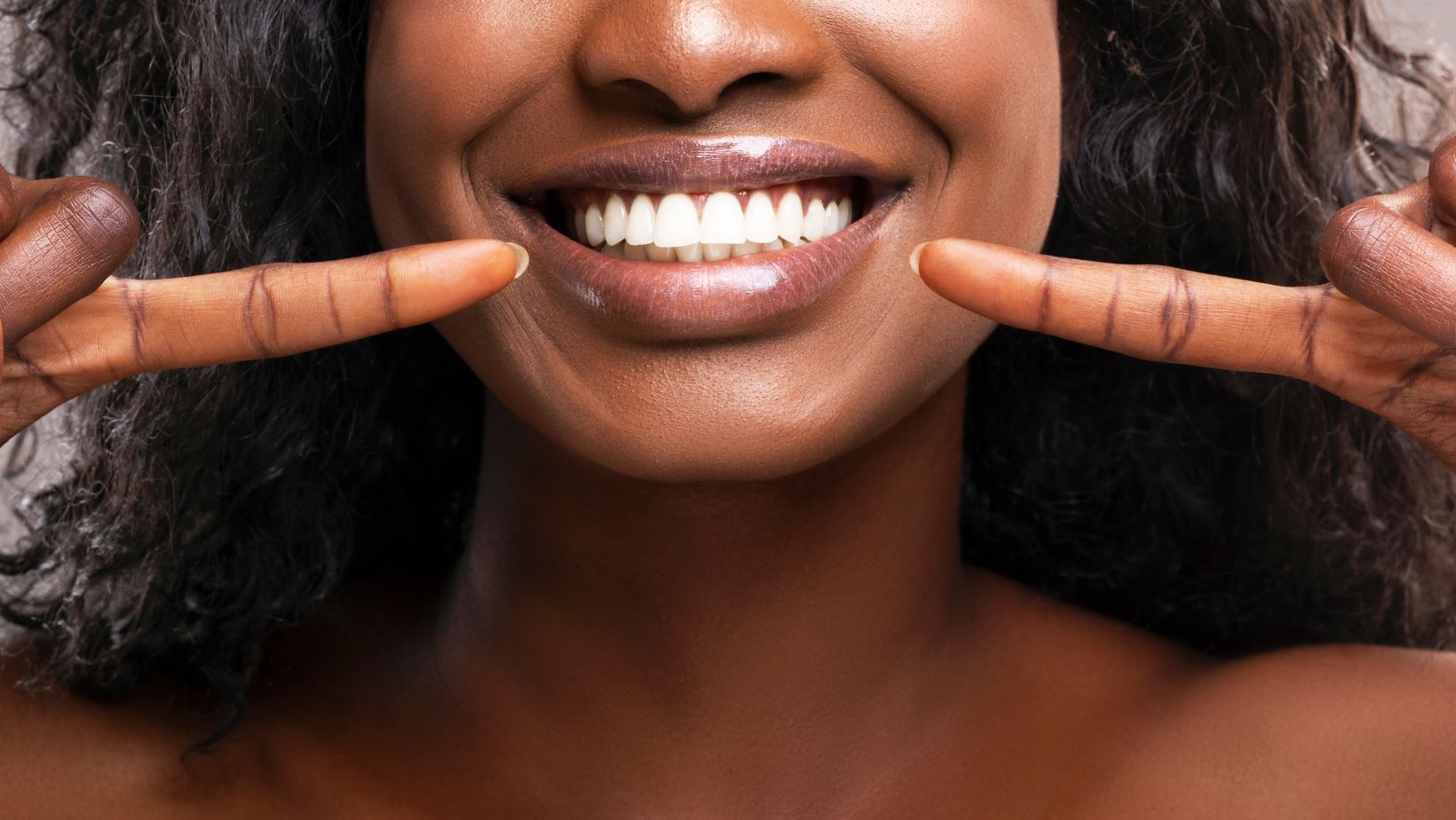 happy patient after teeth whitening at the dentist