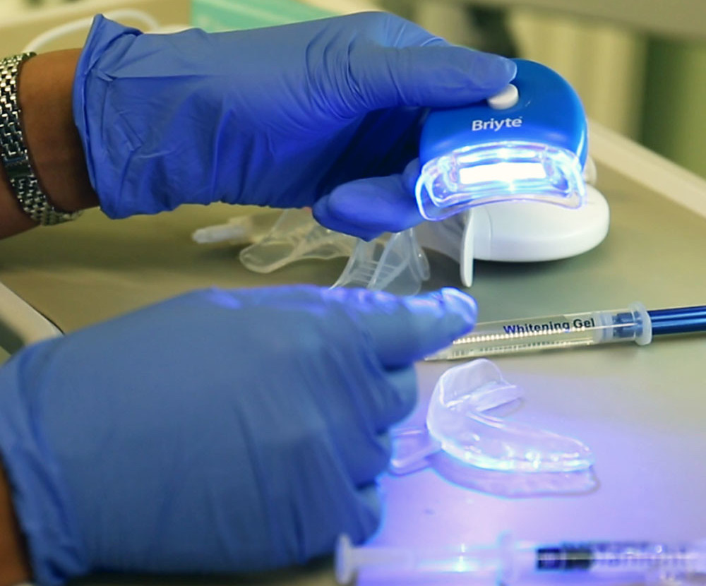 Dentist preparing for a teeth whitening procedure