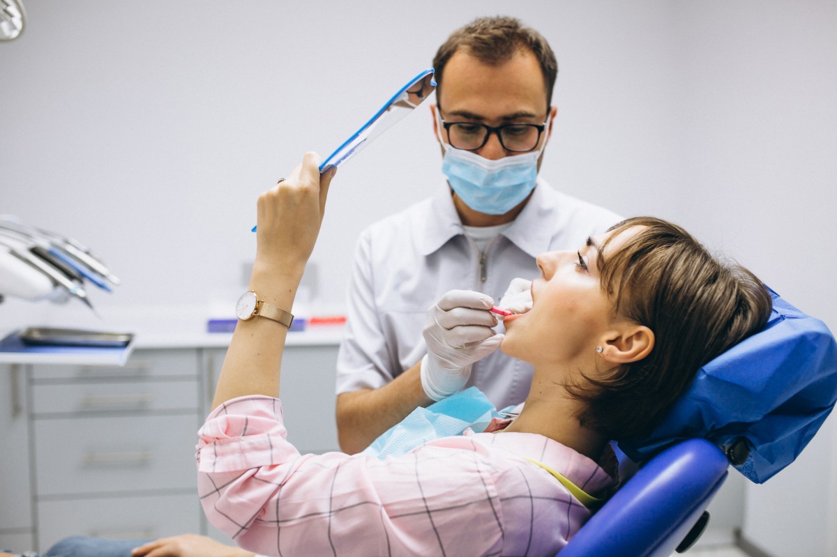 woman in dentist's chair having a chipped tooth fixed